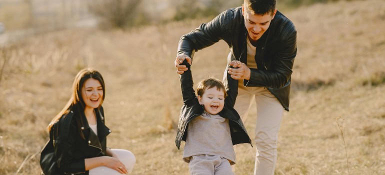 a happy family of three after using the services of one of the moving companies Springfield VA offers