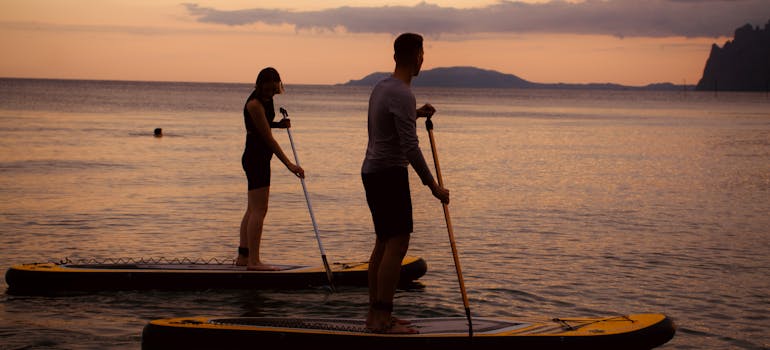 two people paddle-boarding while camping in Northern Virginia