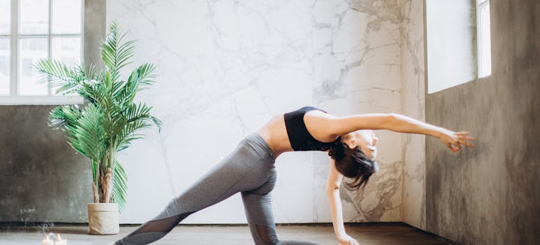 a woman practicing yoga in a room