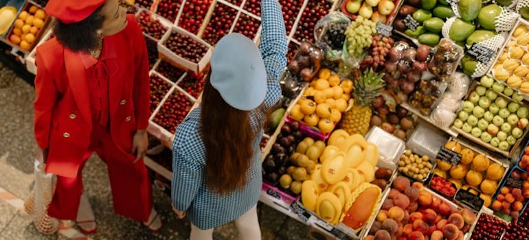 two women buying groceries in a supermarket