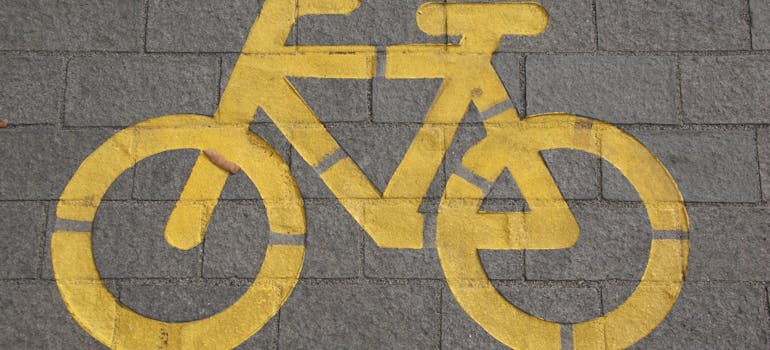 a yellow drawing of a bicycle on the pavement