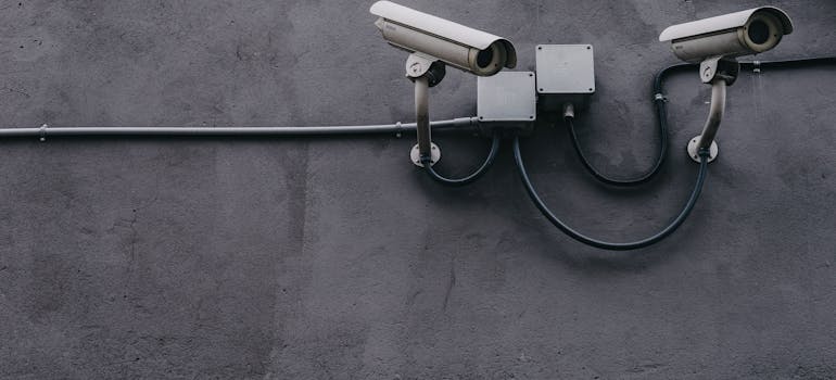 two cameras installed on a wall, indicating someone feels unsafe which is one of the signs that you should move to a different city