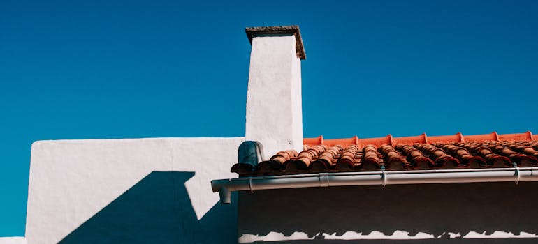 A roof with a gutter that need to be inspected in the course of the home maintenance during the summer