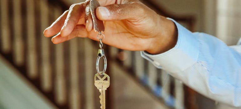 a man holding house keys