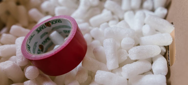 foam peanuts and red duct tape in a box